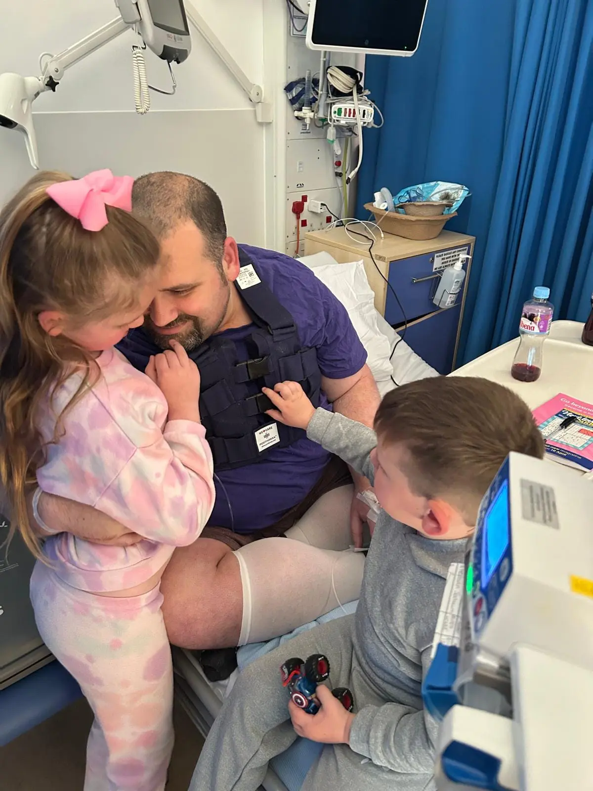 Mark with his two children in hospital